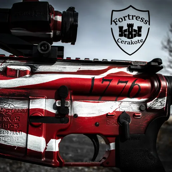Close-up of an AR-15 receiver with a distressed red, white and blue 1776 flag Cerakote finish.