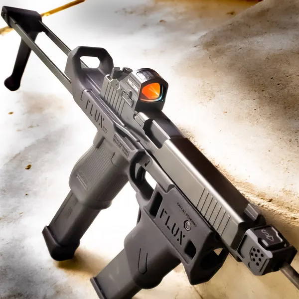 Glock pistol in a Flux Defense chassis with a gray Cerakote finish and red dot optic.